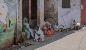 Indian locals sitting outside in Gobardhan, showcasing daily life and culture.